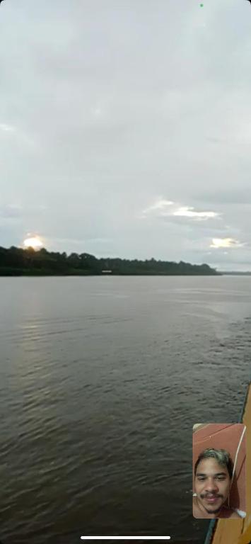 a picture of a man on a boat in the water at Praia dos sonhos 123 in Diadema
