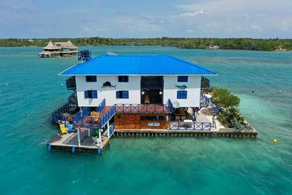 a house on a dock in the water at Hotel Isla Gaviota in Tintipan Island