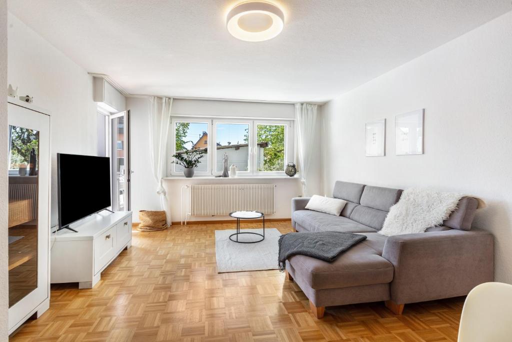 a living room with a couch and a television at K8 Living in Wehr