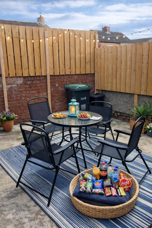a patio with a table and chairs with food on it at Three-Bedroom House Perfect for Contractors and Small Groups, sleeps 5 people in Durham in Bishop Auckland