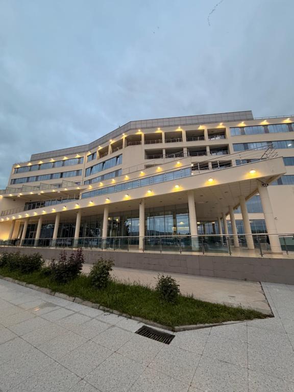a large building with a lot of windows at Arena Hotel Kur in Mingachevir