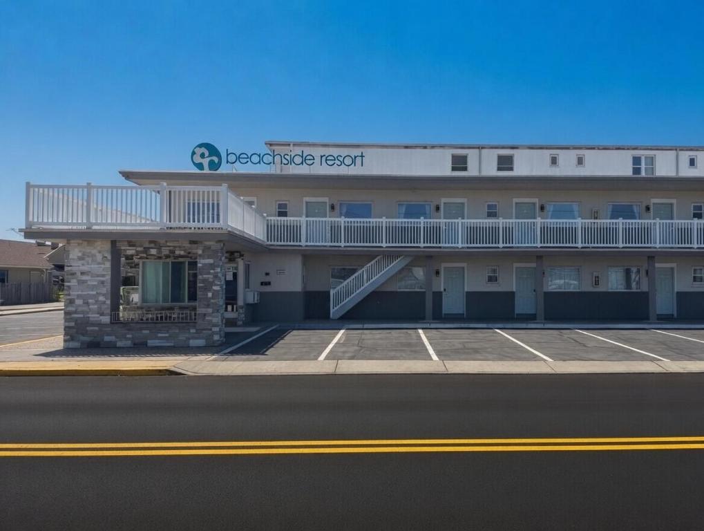 a hotel building with a balcony and a parking lot at Beachside Resort in Wildwood