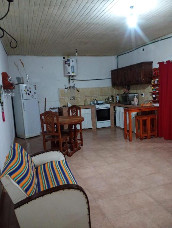 a kitchen with a table and chairs in a room at Alojamiento Ceibo en Flor in Esquina