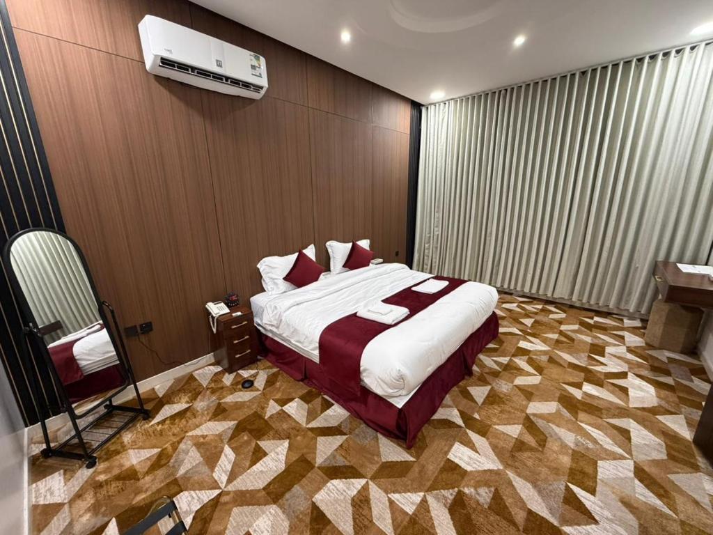 a bedroom with a bed and a television in it at الجوهرة بارك للشقق المخدومة 7 in Riyadh