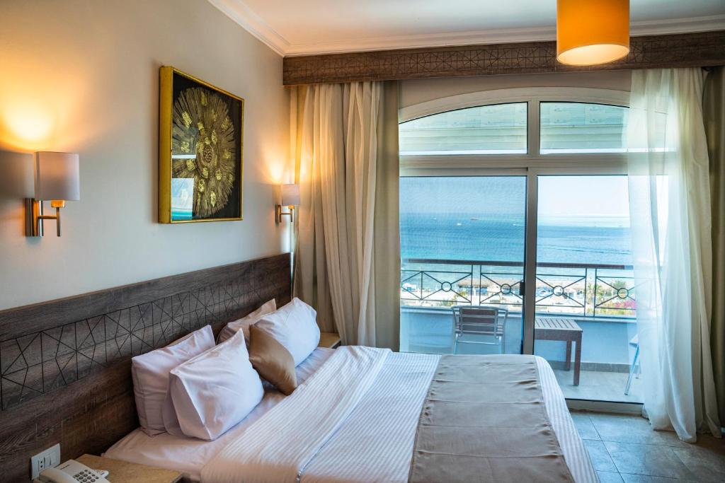 a bedroom with a bed with a view of the ocean at Swiss Wellness Boutique Hotel Hurghada in Hurghada