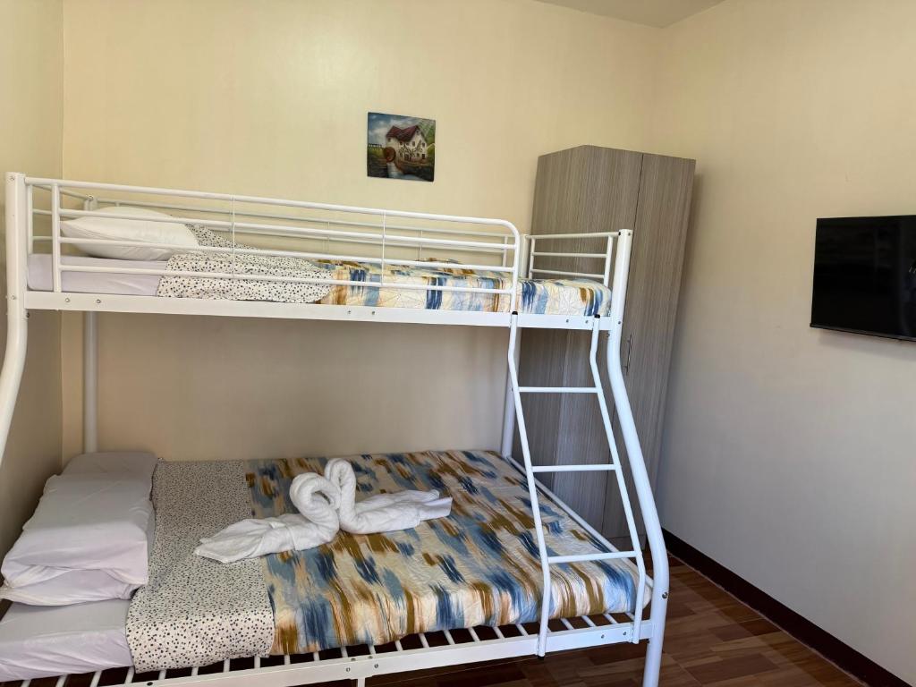 a bunk bed in a small room with a bunk bed at Amad's Rental Space Family Room in Bantayan Island