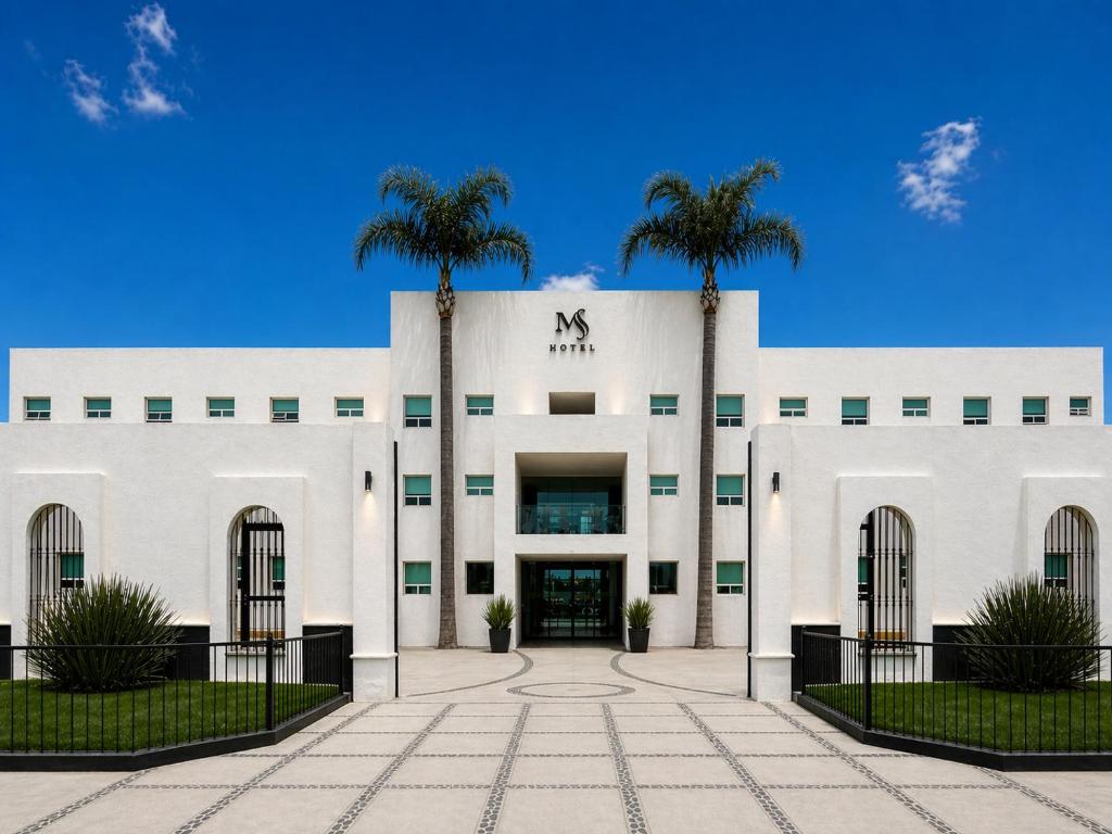 a white building with two palm trees in front at Hotel Posada Maria Sofia in Cholula