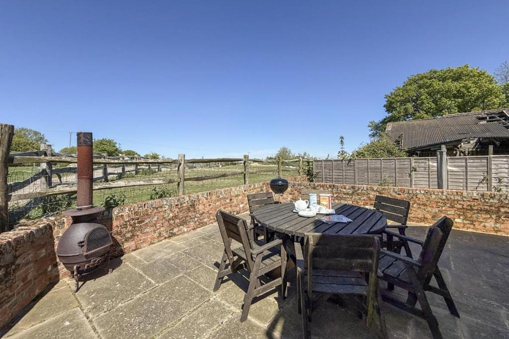 a table and chairs on a patio with a grill at 3 Bed in Tenterden oc-p36303 in Tenterden