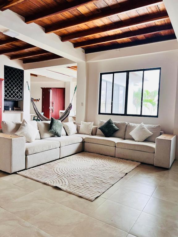 a living room with a couch and a rug at Oceanfront House With Pool and BBQ in San Clemente