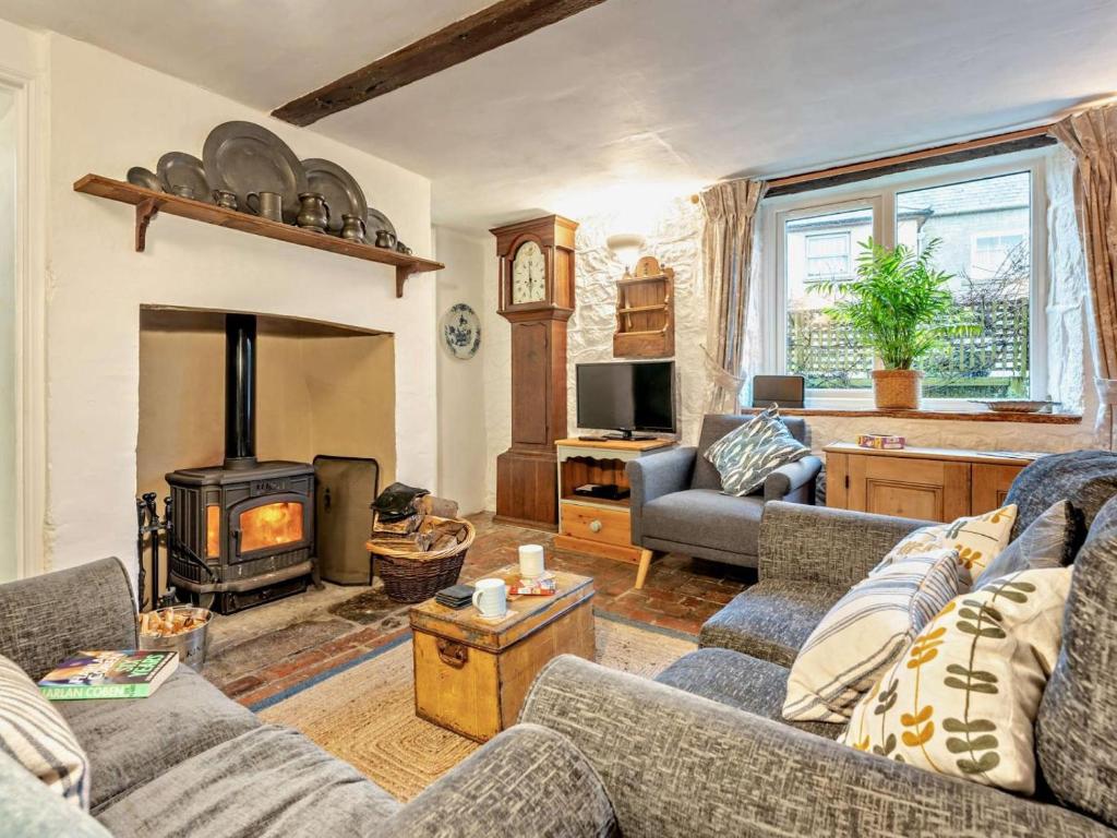 a living room with a couch and a wood stove at 3 Bed in Ventnor oc-93525 in Niton