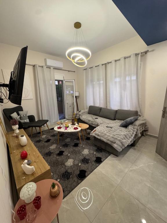 a living room with a couch and a table at Gemini Downtown Apartment in Zakynthos