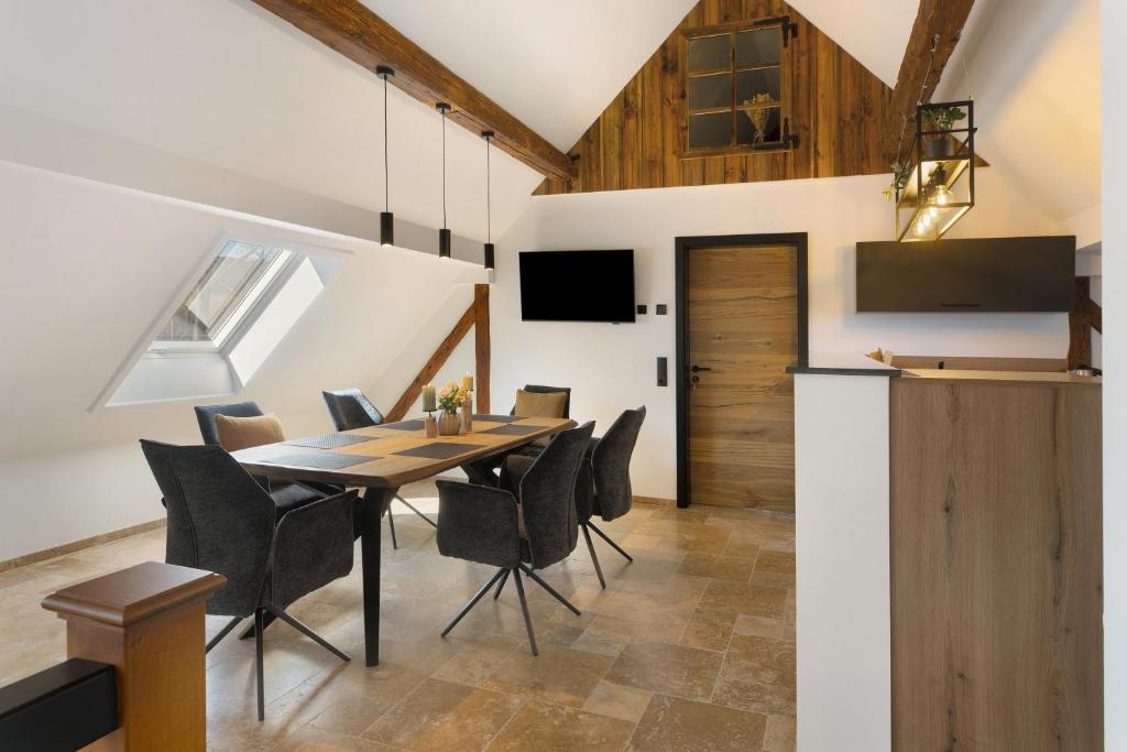 a kitchen and dining room with a table and chairs at Vogtlandstadl - Vogtland Chalet in Bad Brambach