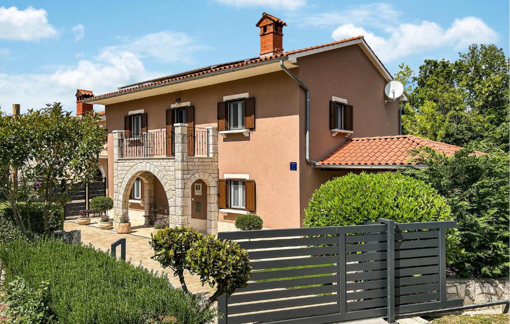 a house with a fence in front of it at Stunning Home In Krsan in Kršan