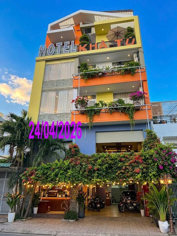 a building with a lot of flowers in front of it at Ngoc Kha Tu 1 Hotel in Long Xuyên