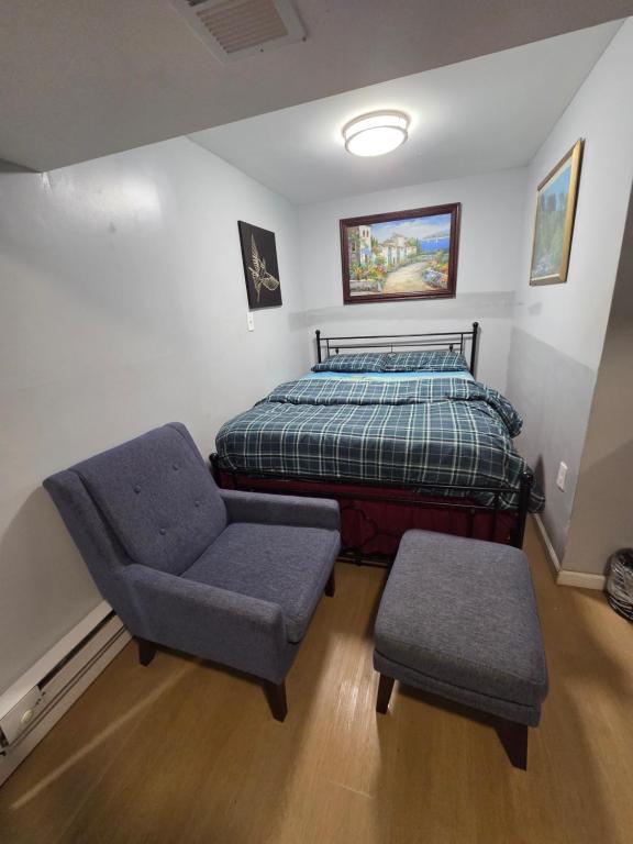 a bedroom with a bed and a chair at Executive private room in Irvington