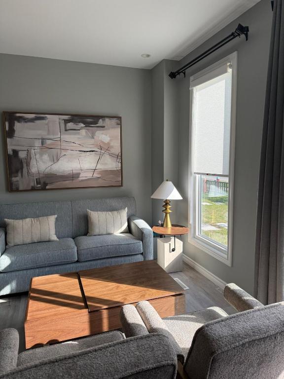 a living room with a couch and a coffee table at Spacious New 3BR Townhome Walking to Falls in Niagara Falls
