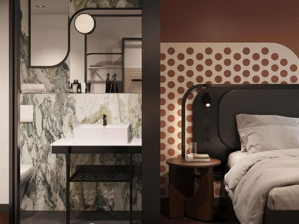 a bathroom with a sink next to a bed at TRIBE PARIS SURESNES in Suresnes
