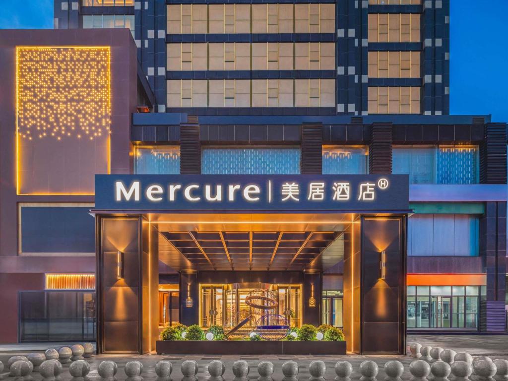 a building with a sign in front of it at Mercure Beijing Future Science City in Beijing