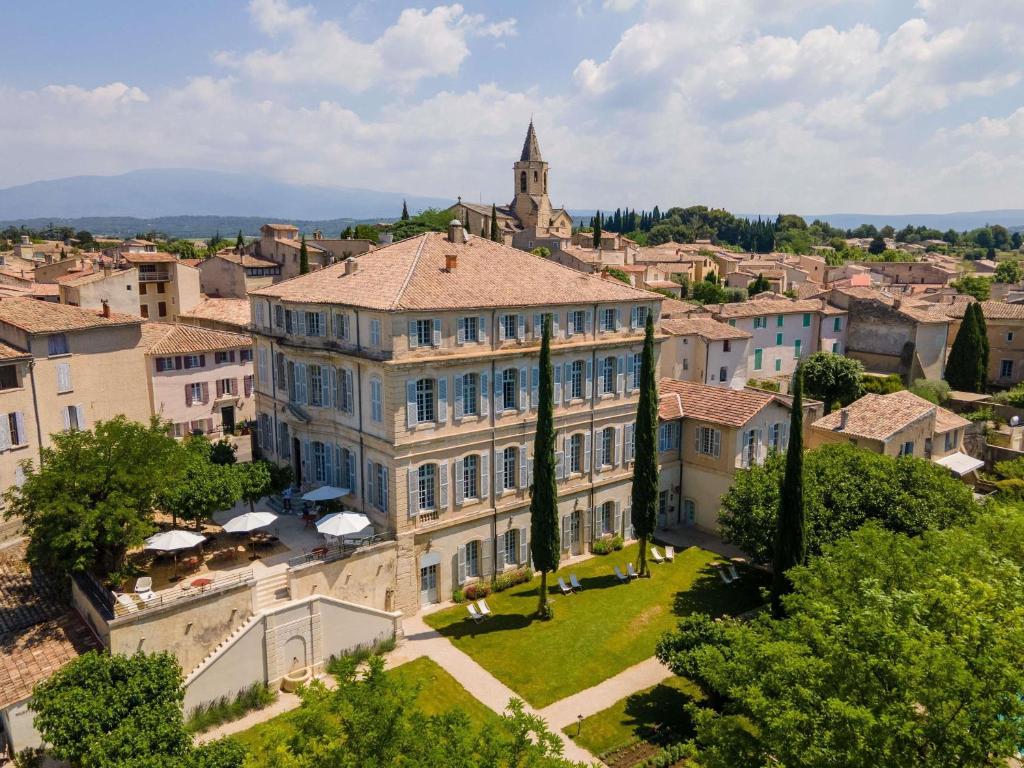an aerial view of a building in a city at Château de Mazan - Handwritten Collection in Mazan