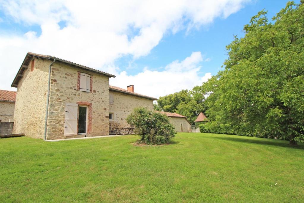an exterior view of a house with a yard at Le petit feuillade in Saint-Laurent-sur-Gorre