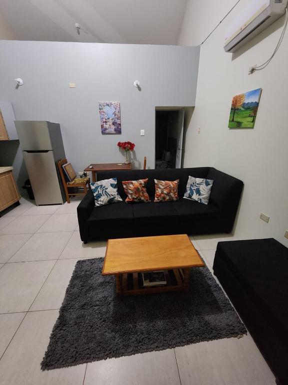 a living room with a black couch and a coffee table at Crown Point Condos by Nasin in Crown Point
