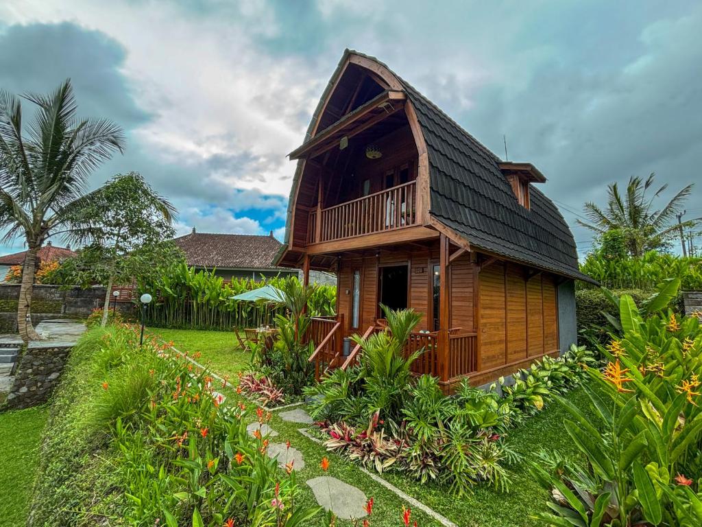 a wooden house with a gambrel roof at Casa Vella Cottages by AGATA in Bedugul