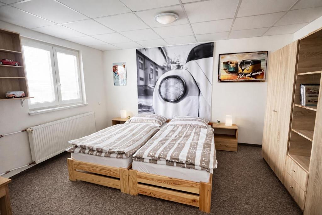 a bedroom with a bed and a clock on the wall at Ubytování U Ropáků in Horní Slavkov