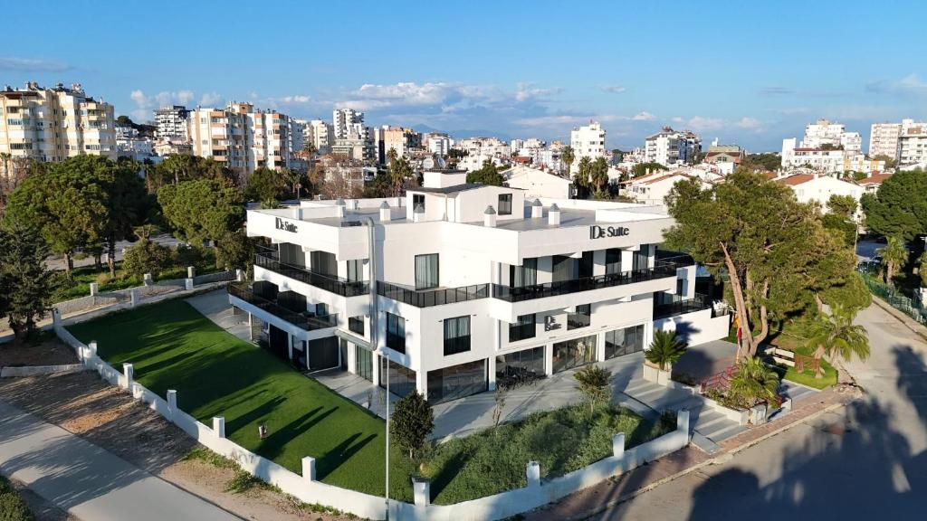 an aerial view of a white building with a yard at De Suite Hotel in Antalya