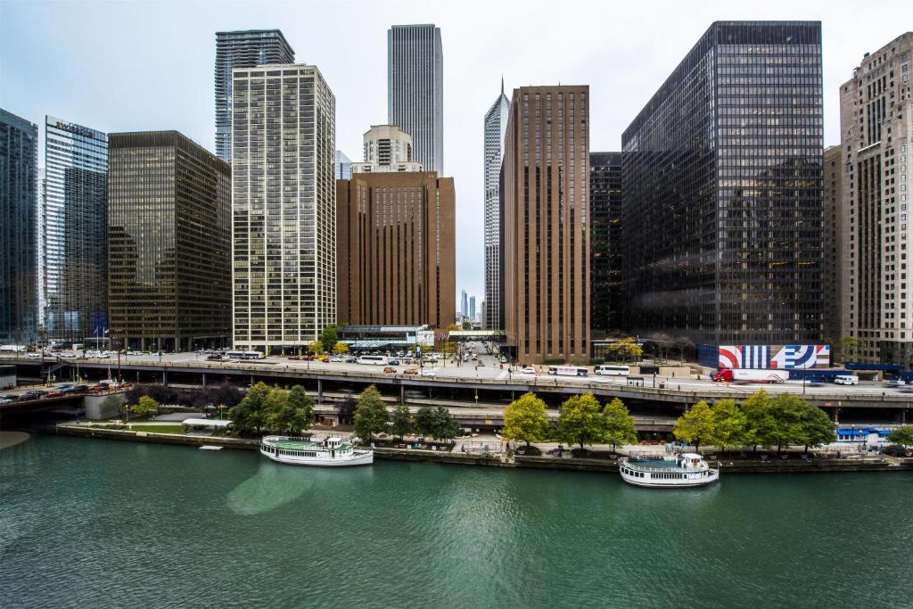 a river with boats in a city with tall buildings at Hyatt Regency Chicago in Chicago
