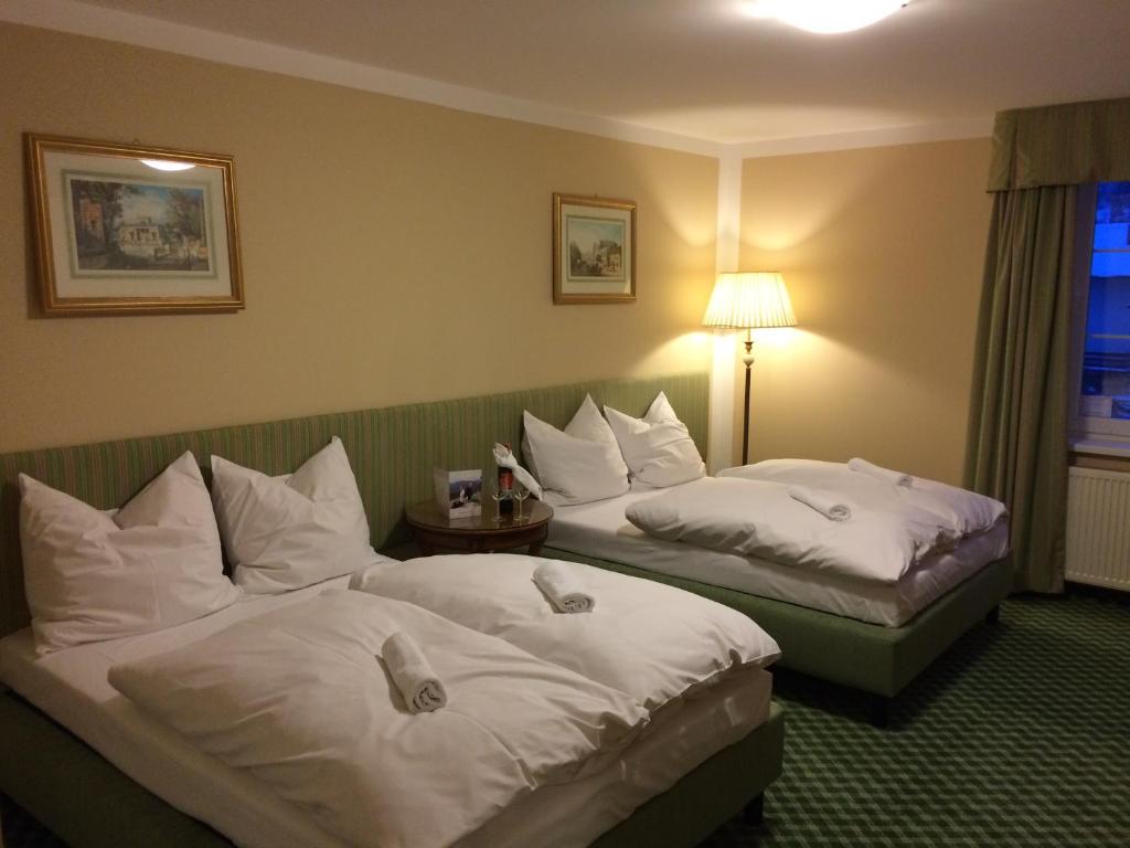 a hotel room with two beds with white pillows at Pensjonat BELVEDERE in Szczyrk