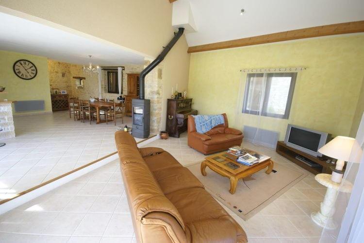 a large living room with a couch and a tv at Proche de Rocamadour in Montcléra