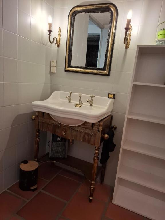 a bathroom with a sink and a mirror at Gite des arches in Saint-Nectaire