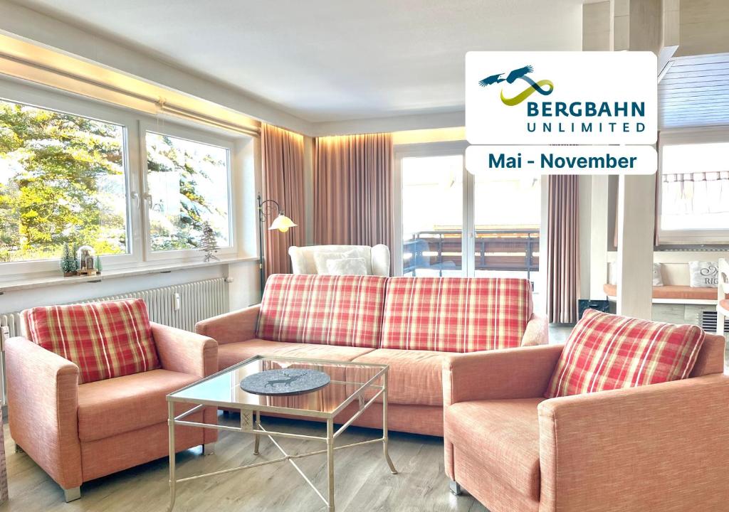a living room with two couches and a table at Bergsonne B15 Montana Haus in Oberstdorf