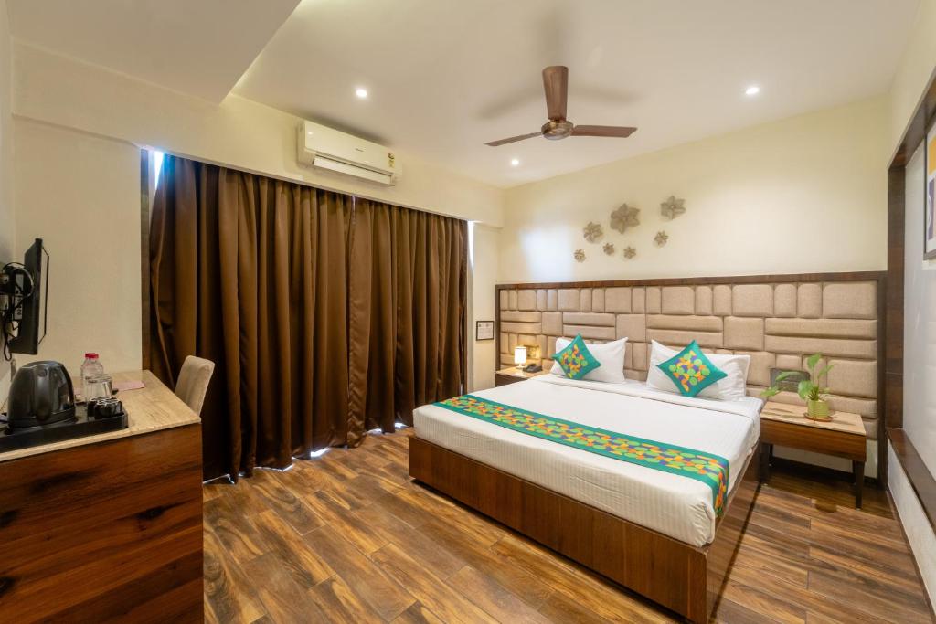 a bedroom with a large bed in a room at Treebo Calangute Beach Stay in Calangute