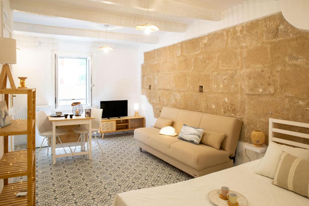 a living room with a couch and a table at Petit Buragna in Alghero