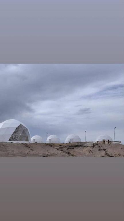 a group of domes in the middle of a desert at AK chatyr in Tong