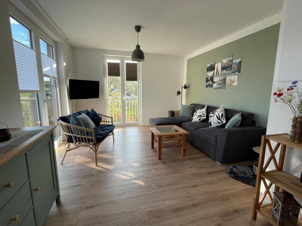 a living room with a couch and a table at Bei Kleins in Nümbrecht
