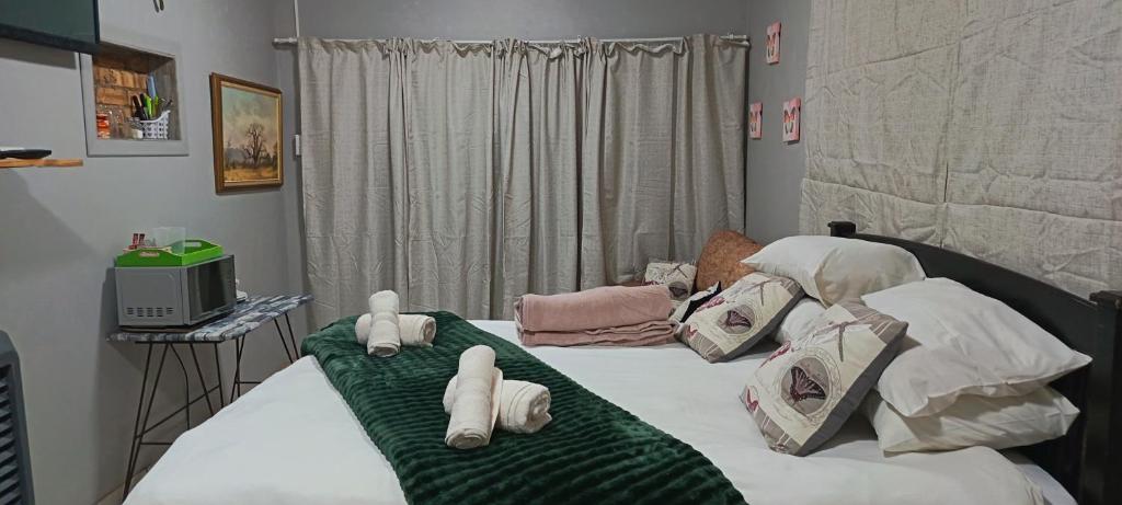 a bedroom with two beds with pillows on them at Malan's Siësta 2 in Kimberley