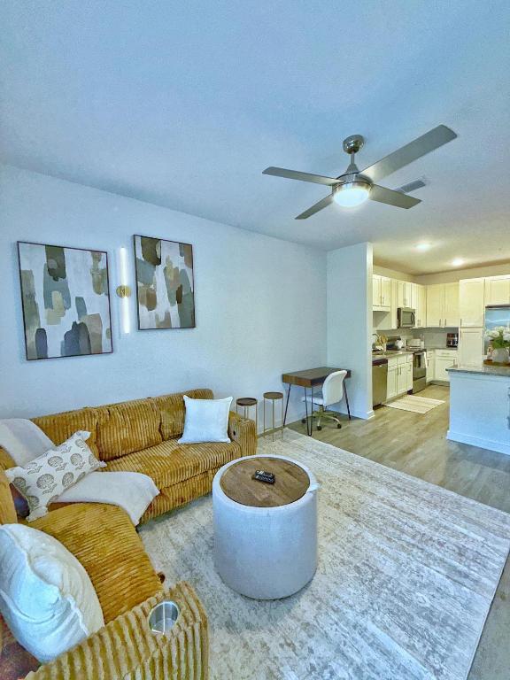 a living room with a couch and a ceiling fan at Beachline Oasis in Jacksonville