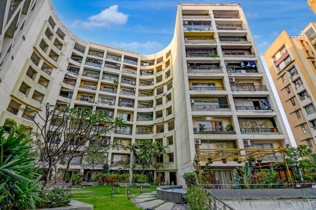 a large apartment building with balconies and trees at The Zean Luxury in Jāmb