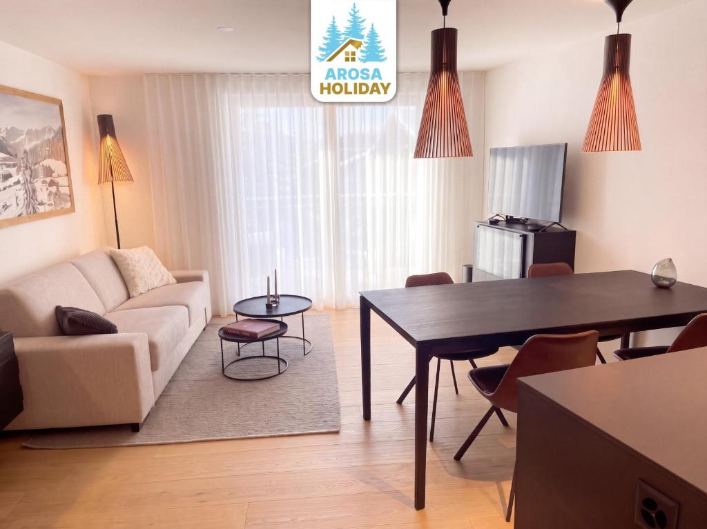 a living room with a couch and a table at Koller Sapuen by Arosa Holiday in Arosa