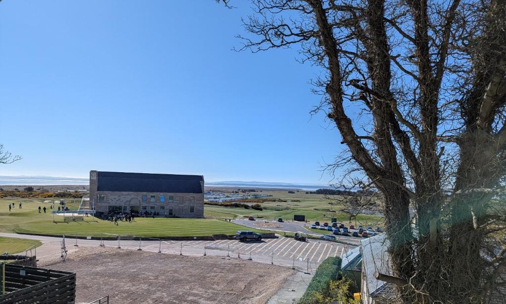 a view of a building with a tree at Royal Gardens Apartment 10 in Dornoch