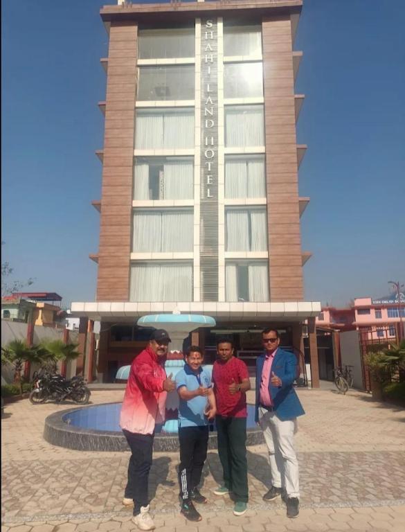 a group of people standing in front of a building at Shahi Land Hotel Pvt Ltd in Butwāl