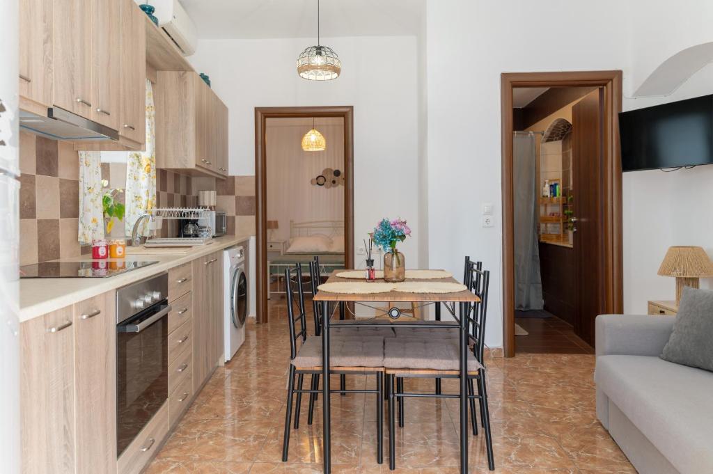 a kitchen and living room with a table and chairs at The Stone Nest in Kefalos