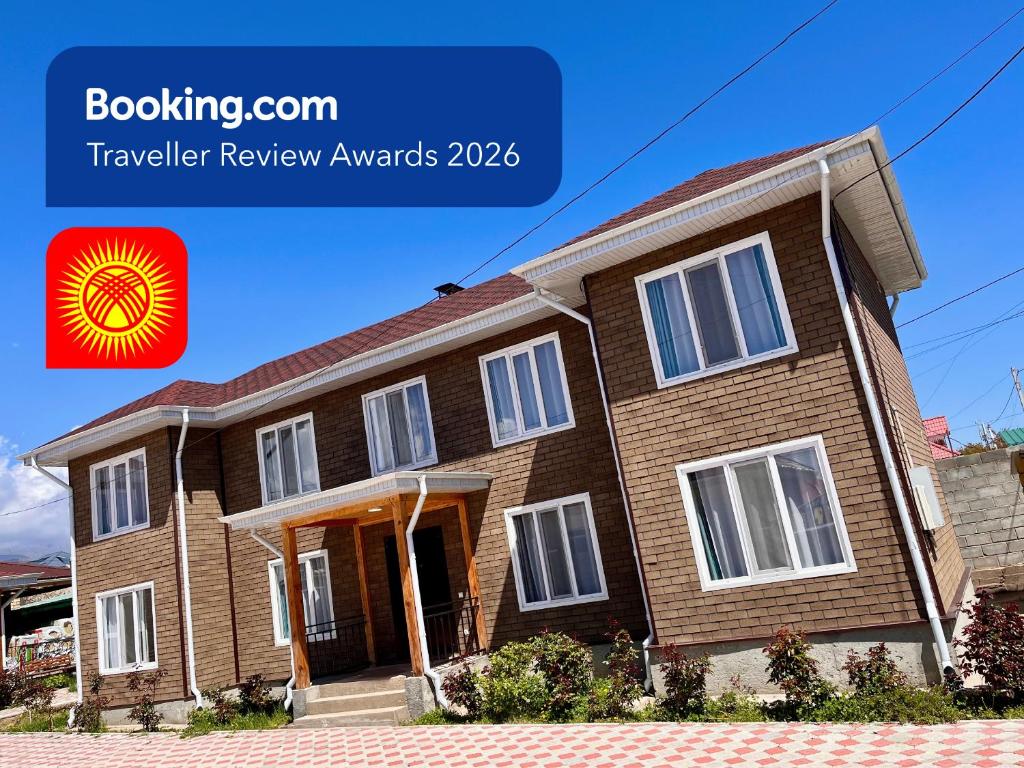 a brown brick house with the words traveller review awaits at Sunrise House in Cholpon-Ata