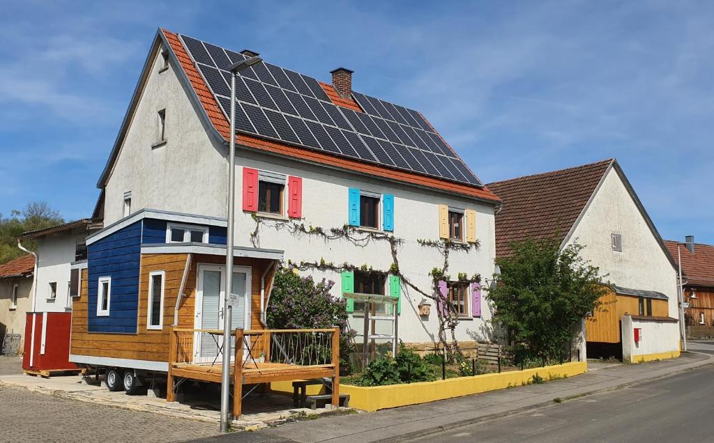 a house with solar panels on top of it at Tinyhouse Rhön-Saale in Wülfershausen