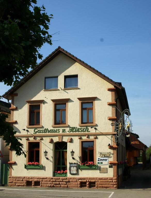 a building with a sign on the front of it at Gasthaus zum Hirsch Hotel - Restaurant in Weier