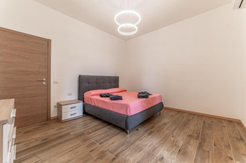 a bedroom with a bed and a wooden floor at Chateau De La Rose in Fonte Nuova