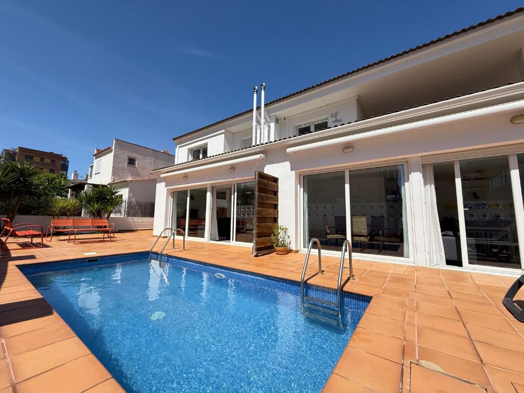 a swimming pool in front of a house at Agi Las Acacias in Roses