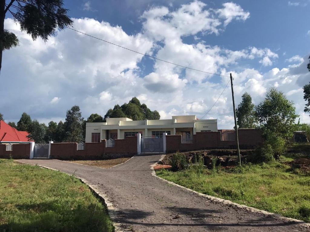 a house on the side of a road at Bella Famiglia in Ruhengeri